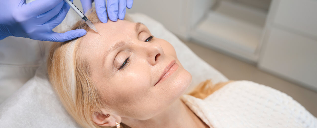 Woman gets botox at a medspa - cropped